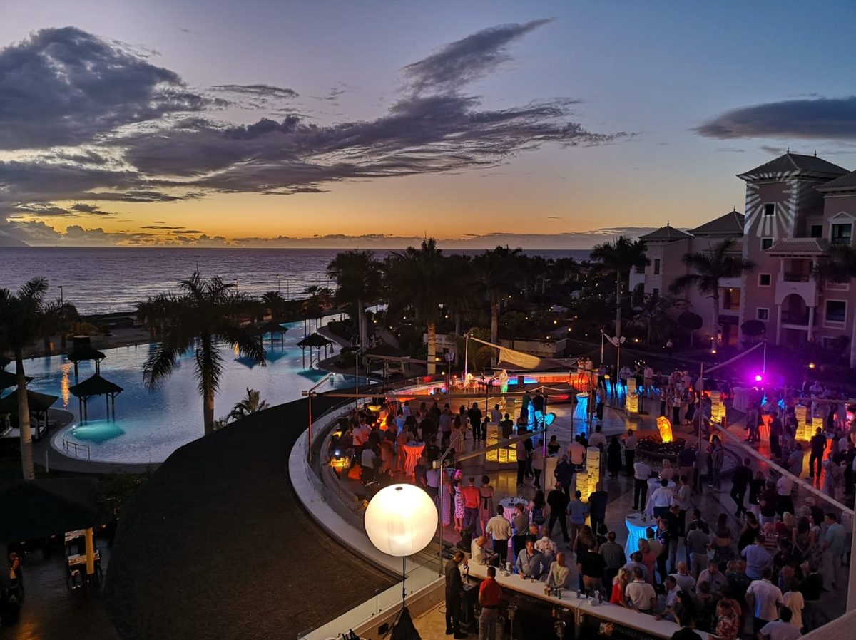Evening wedding party on a seafront terrace at sunset